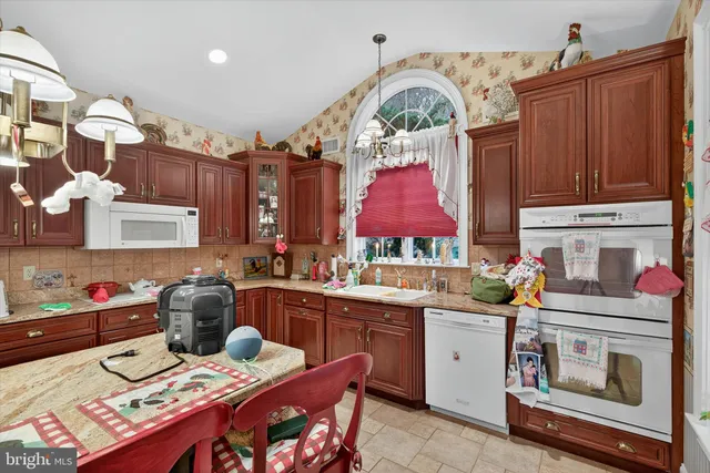 a view of a dining room with furniture and chandelier