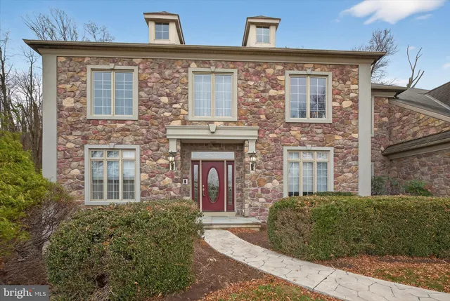 front view of a brick house with a small yard