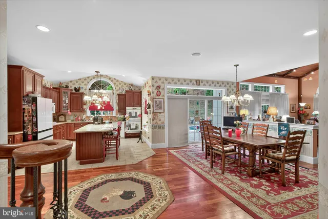 a view of a dining room with furniture and chandelier