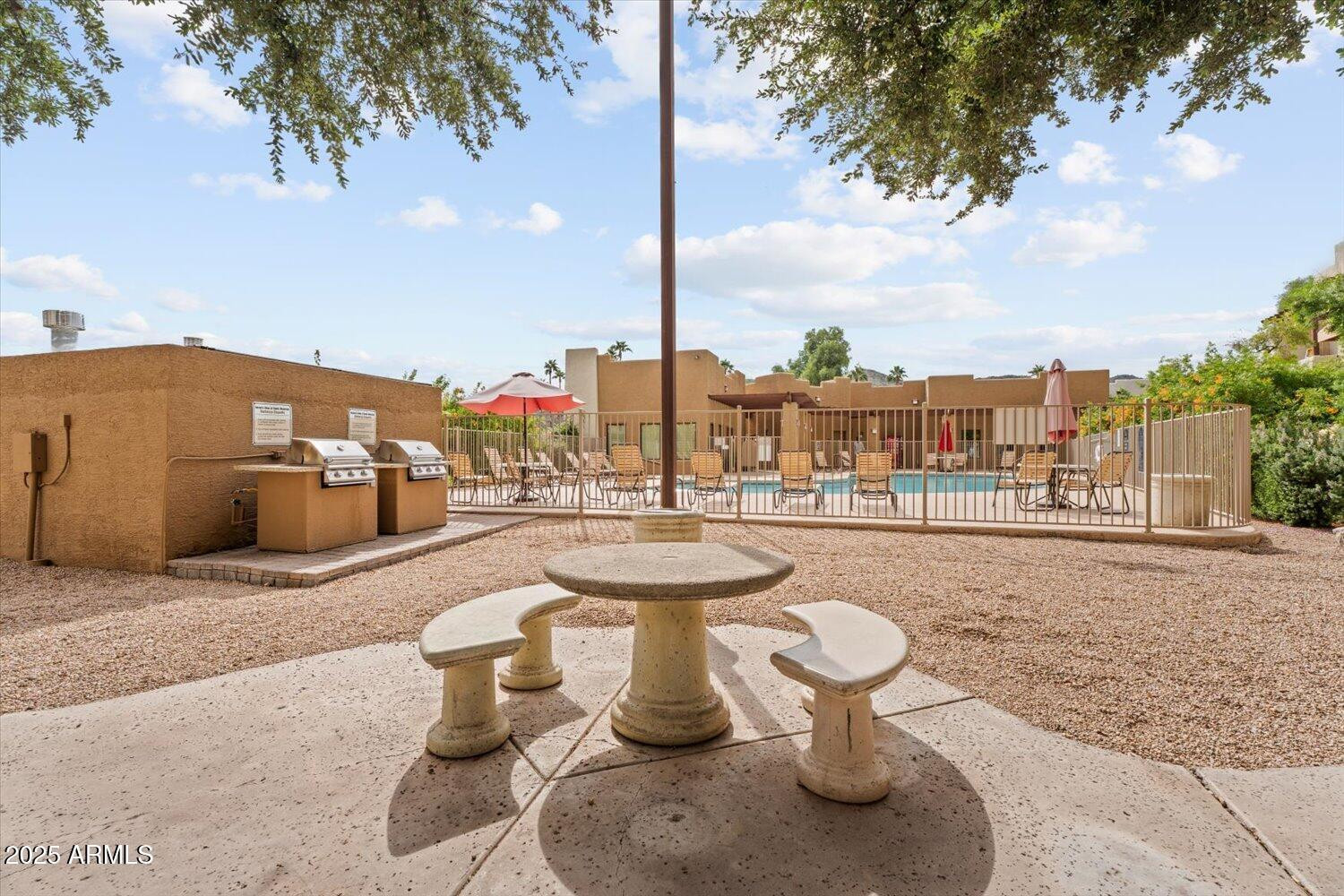 3434 East Baseline Road, Unit 260 Phoenix, AZ 85042 - Photo 14 of 15 a view of a patio with couches and potted plants