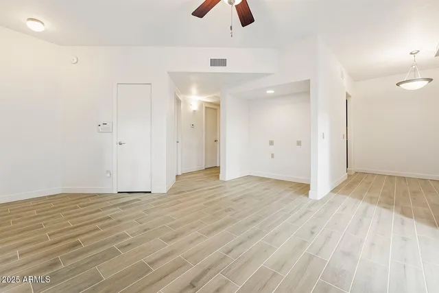 a view of an empty room with wooden floor