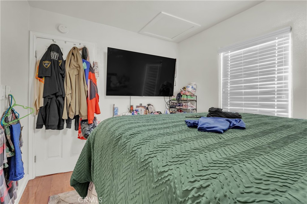 141 West 83rd Street Los Angeles, CA 90003 - Photo 14 of 22 a bed room with a bed and a flat screen tv