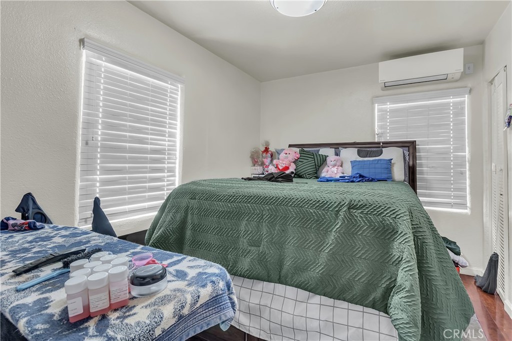 141 West 83rd Street Los Angeles, CA 90003 - Photo 16 of 22 a bedroom with a bed and two windows