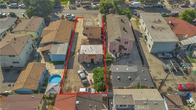 an aerial view of residential houses with outdoor space