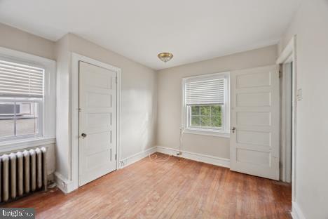 7011 Hazel Avenue Upper Darby, PA 19082 - Photo 11 of 16 an empty room with wooden floor and windows