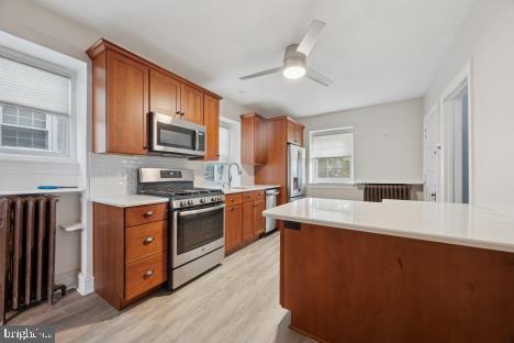 7011 Hazel Avenue Upper Darby, PA 19082 - Photo 6 of 16 a kitchen with stainless steel appliances granite countertop a sink stove microwave and refrigerator