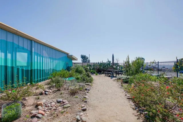 a backyard of a house with plants and outdoor seating