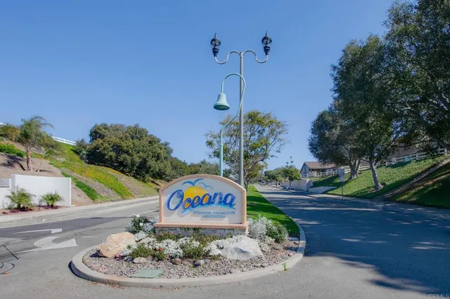 a sign board with a play ground in the back