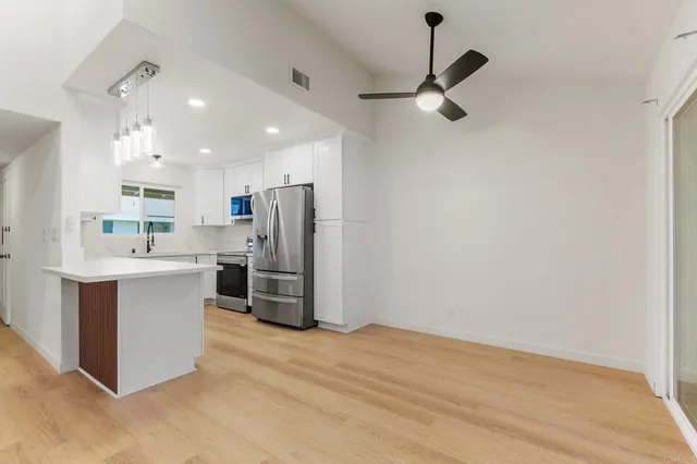 a kitchen with stainless steel appliances a refrigerator sink and cabinets