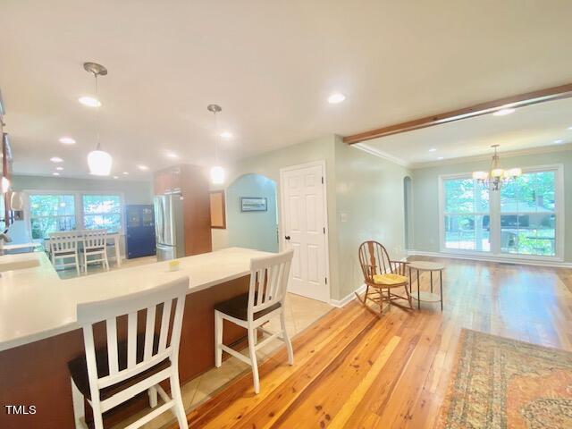 4400 Currie Court Raleigh, NC 27613 - Photo 11 of 35 a view of a dining room with furniture wooden floor and a chandelier