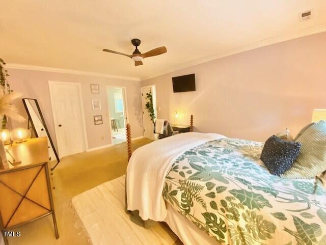 4400 Currie Court Raleigh, NC 27613 - Photo 19 of 35 a bedroom with a bed and a chandelier