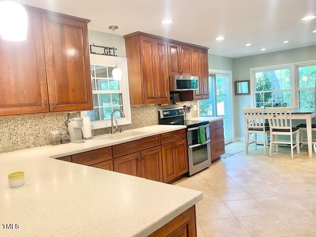 4400 Currie Court Raleigh, NC 27613 - Photo 5 of 35 a kitchen with stainless steel appliances kitchen island granite countertop a sink and cabinets