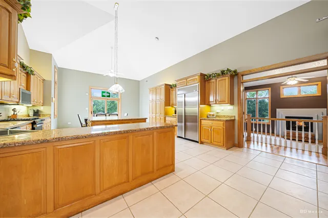 a bathroom with a granite countertop sink and a large mirror