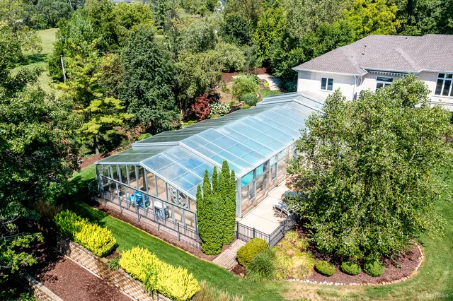 a view of a house with a yard and potted plants