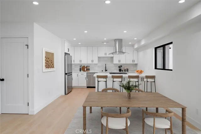 a large kitchen with a table and chairs