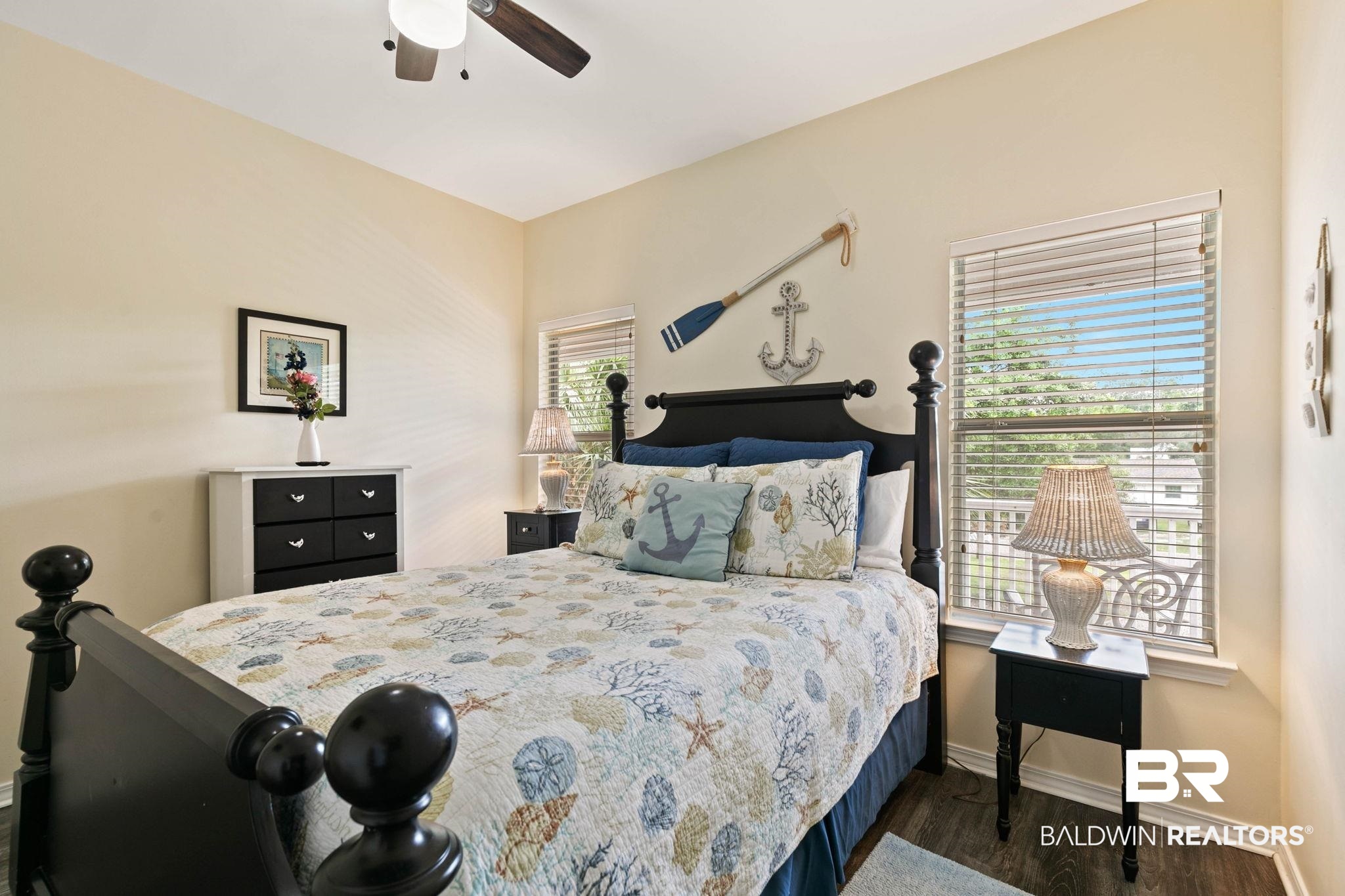 6802 Shore Drive Elberta, AL 36530 - Photo 20 of 34 Bedroom featuring dark wood-finish flooring, light-toned walls, and a ceiling fan with integrated lighting