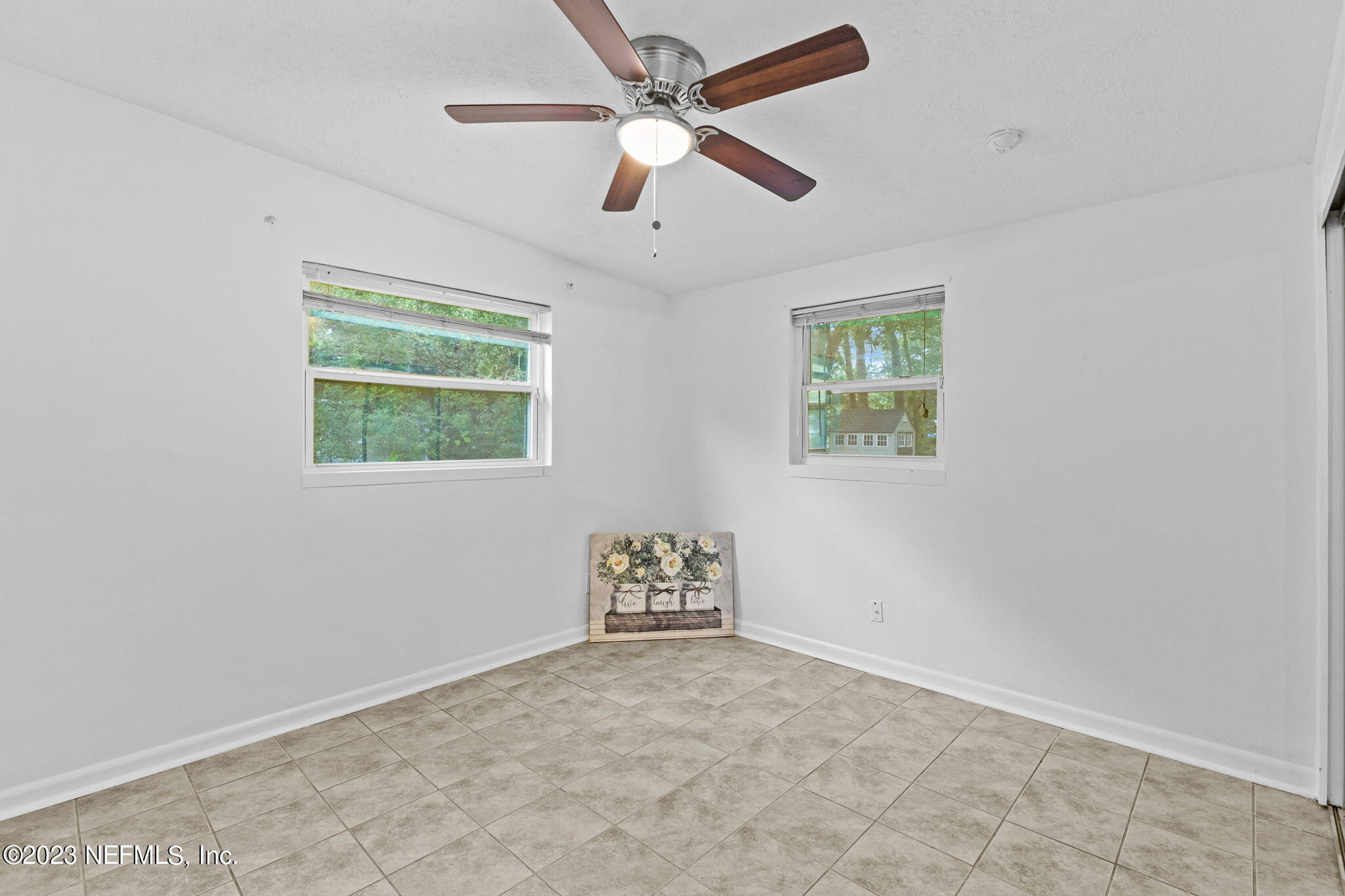 6831 Morgana Road North Jacksonville, FL 32211 - Photo 7 of 25 an empty room with windows and ceiling fan
