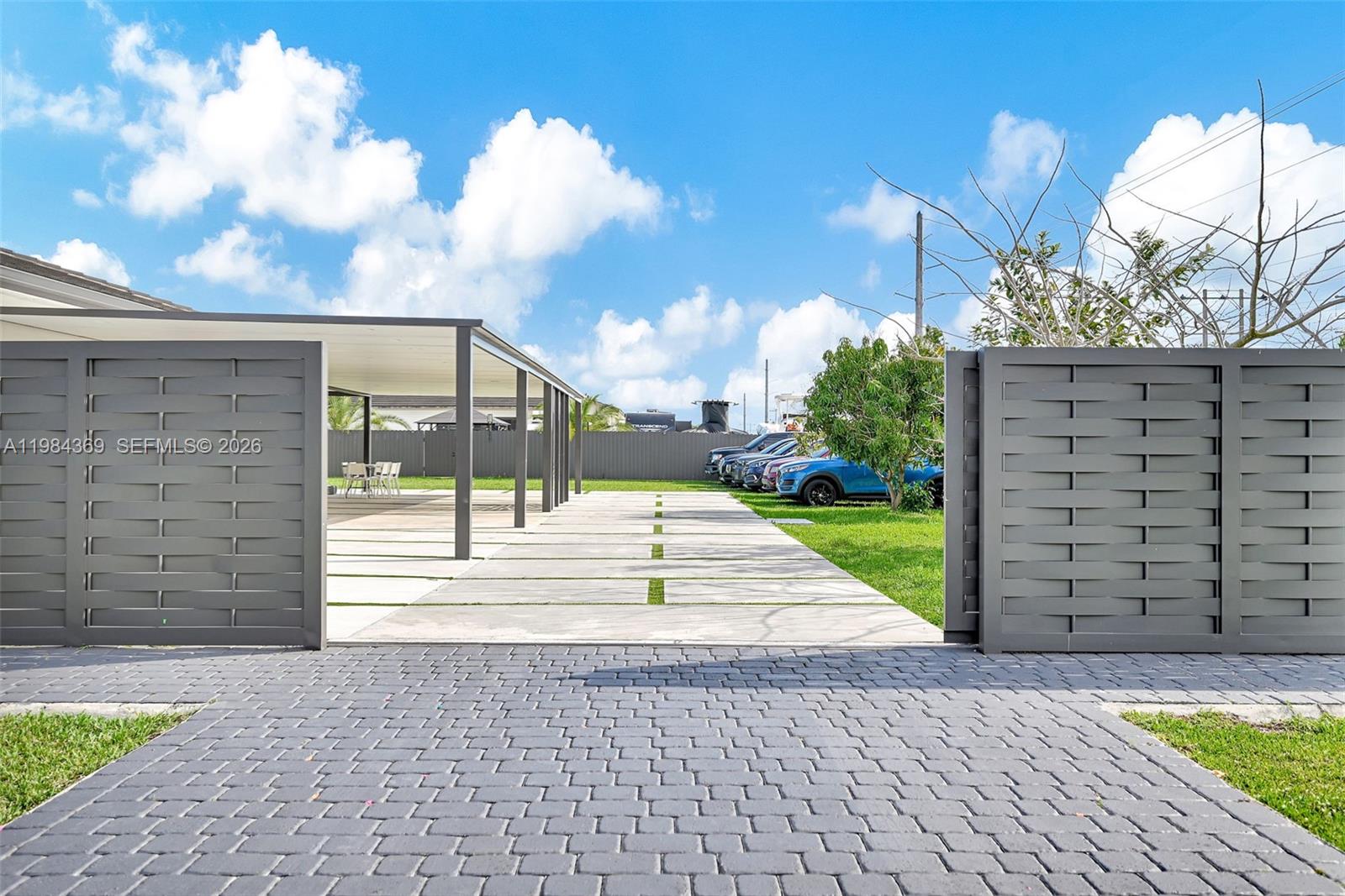 13334 Southwest 227th Street Miami, FL 33170 - Photo 20 of 69 a view of a pathway with a wrought fence