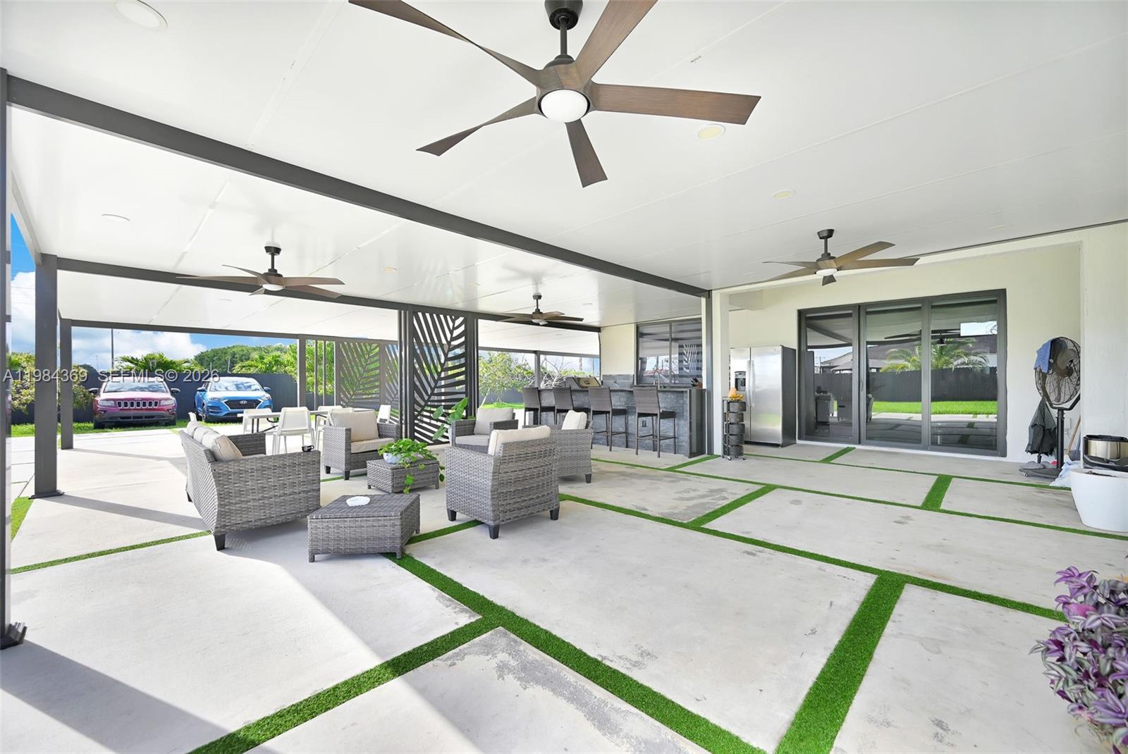 13334 Southwest 227th Street Miami, FL 33170 - Photo 27 of 69 a living room with patio furniture and a floor to ceiling window
