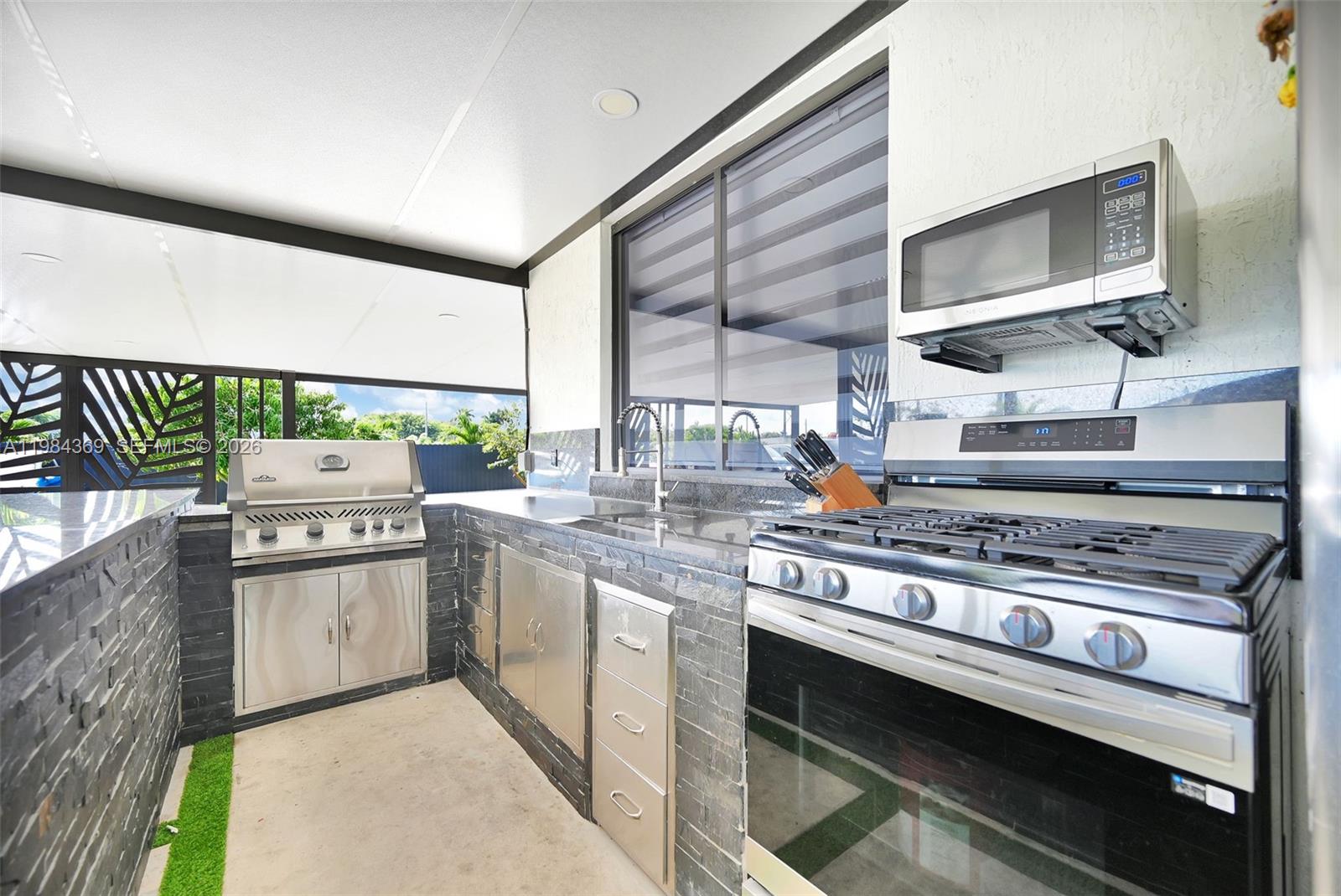 13334 Southwest 227th Street Miami, FL 33170 - Photo 33 of 69 a kitchen with stainless steel appliances a stove and a microwave