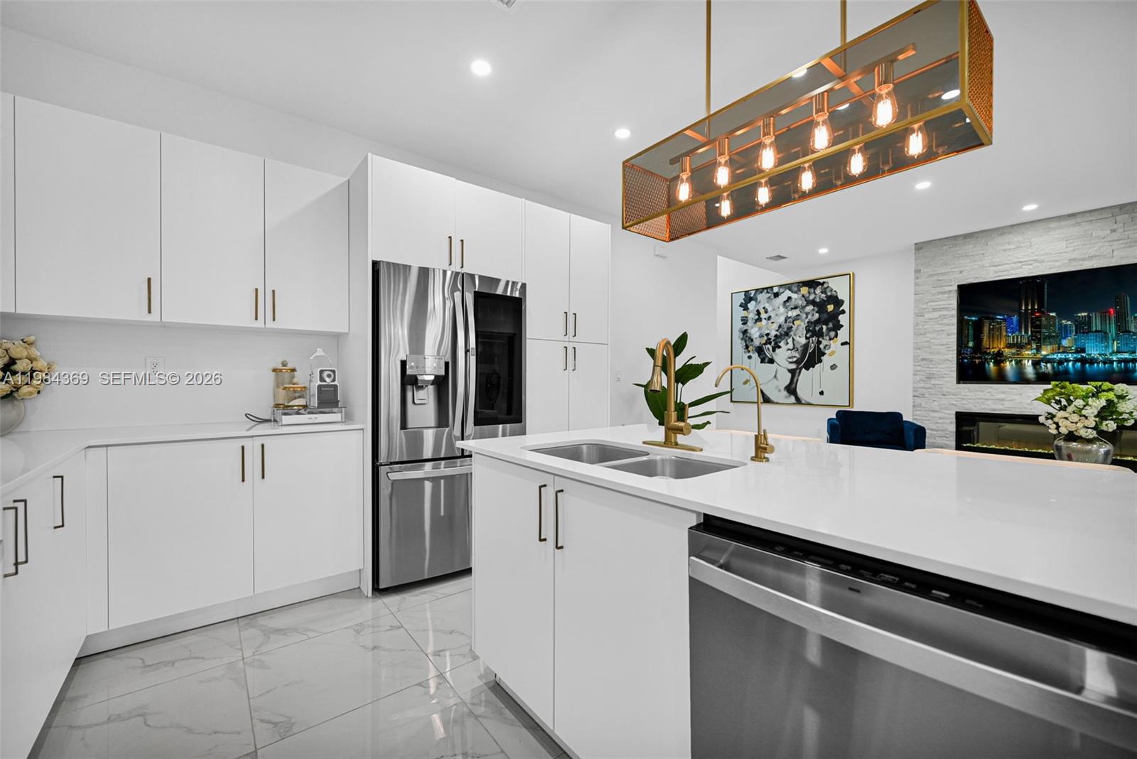 13334 Southwest 227th Street Miami, FL 33170 - Photo 44 of 69 a kitchen with a sink stainless steel appliances and white cabinets