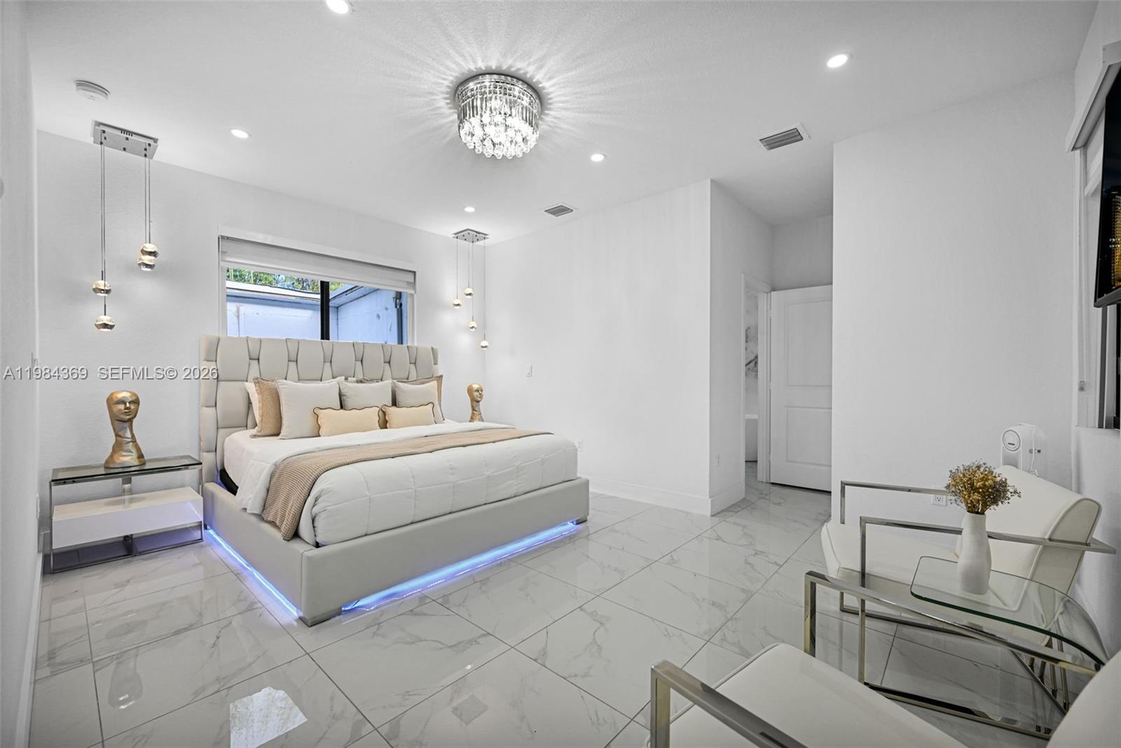 13334 Southwest 227th Street Miami, FL 33170 - Photo 50 of 69 a bedroom with a bed and a chandelier