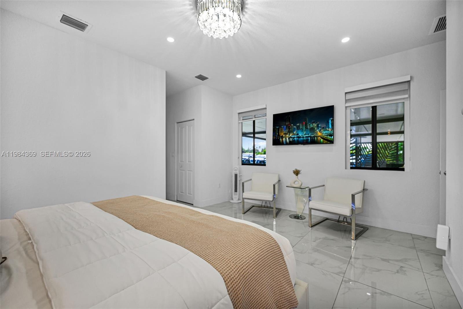 13334 Southwest 227th Street Miami, FL 33170 - Photo 51 of 69 a spacious bedroom with a bed and a flat screen tv