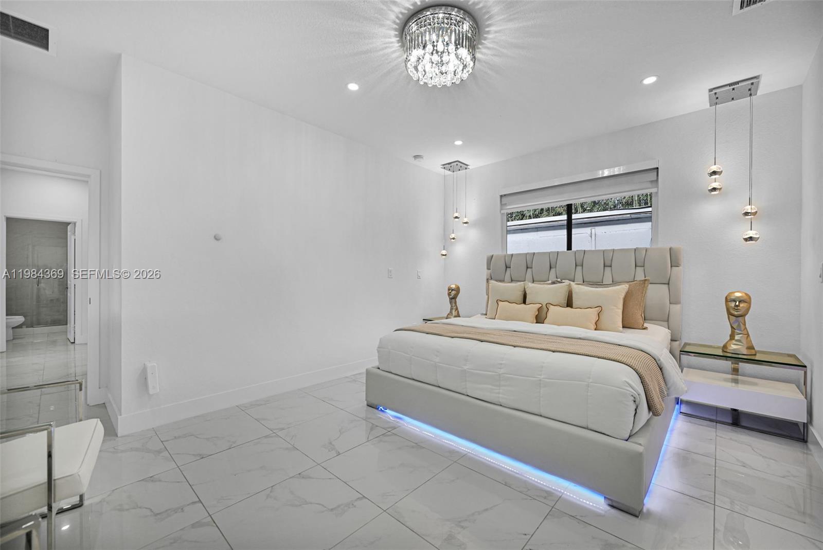 13334 Southwest 227th Street Miami, FL 33170 - Photo 52 of 69 a bedroom with a bed and a chandelier
