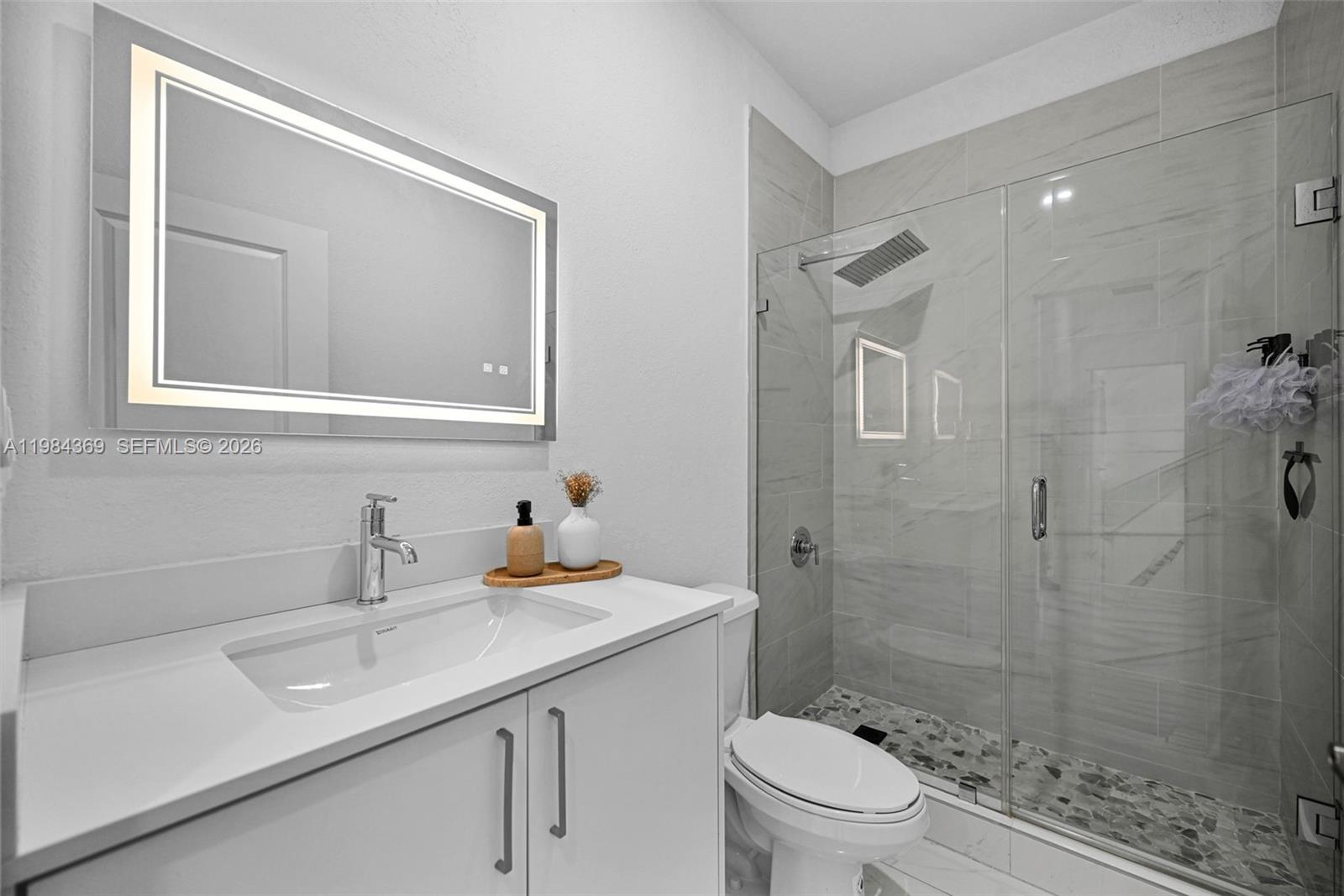 13334 Southwest 227th Street Miami, FL 33170 - Photo 59 of 69 a bathroom with a sink a toilet and shower