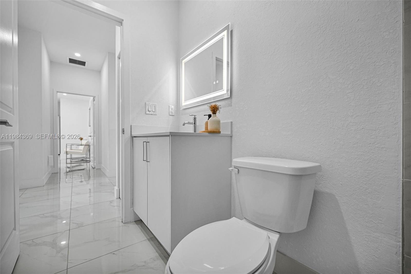 13334 Southwest 227th Street Miami, FL 33170 - Photo 60 of 69 a white toilet sitting next to a bathroom sink