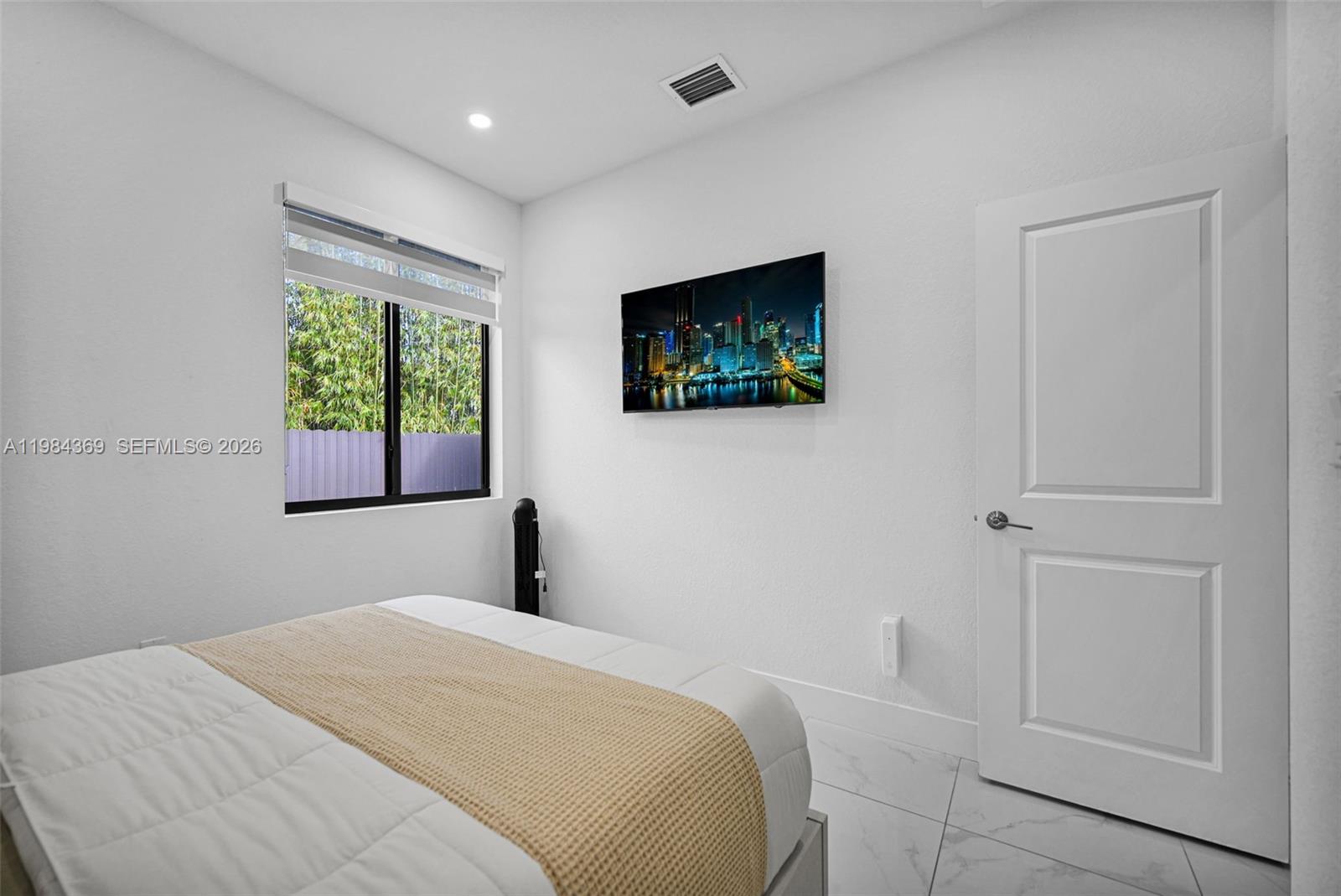 13334 Southwest 227th Street Miami, FL 33170 - Photo 62 of 69 a bedroom with a bed and a flat screen tv