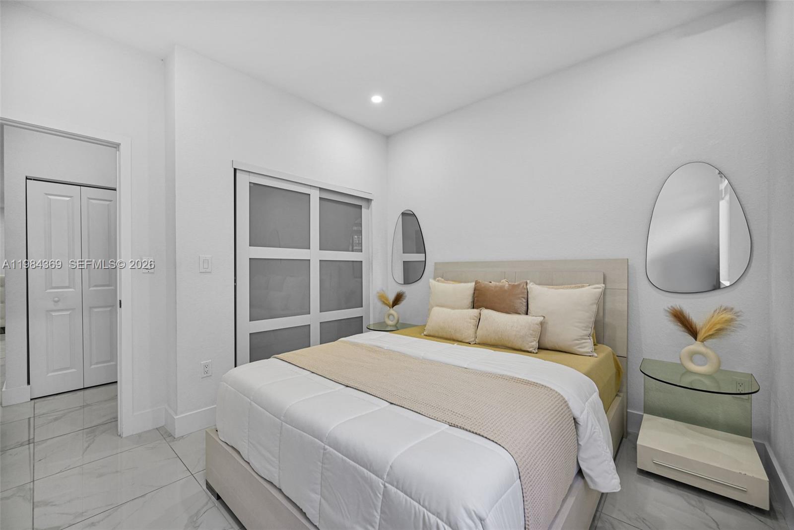 13334 Southwest 227th Street Miami, FL 33170 - Photo 63 of 69 a bedroom with a large bed and a mirror