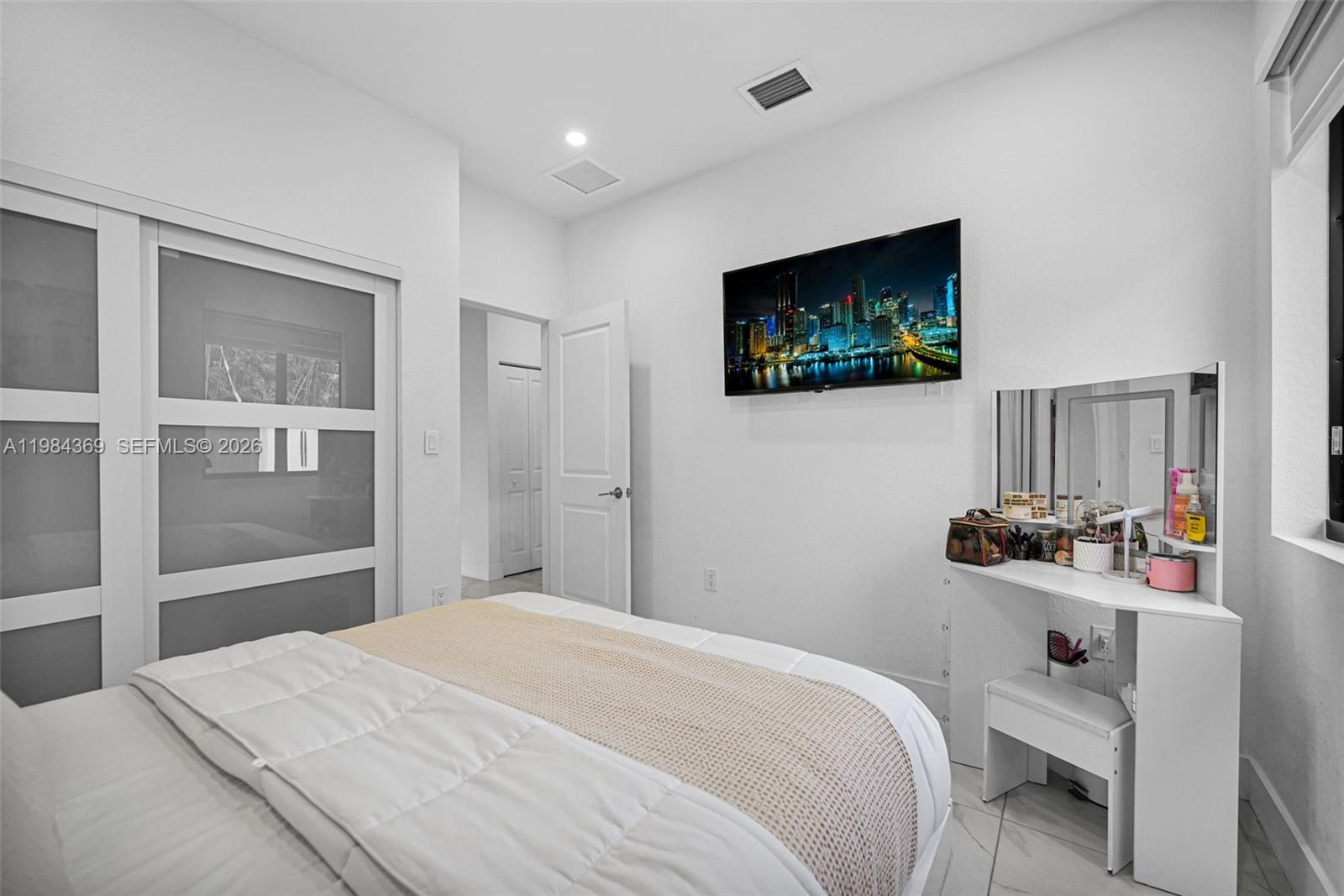 13334 Southwest 227th Street Miami, FL 33170 - Photo 66 of 69 a bedroom with a bed and a flat screen tv