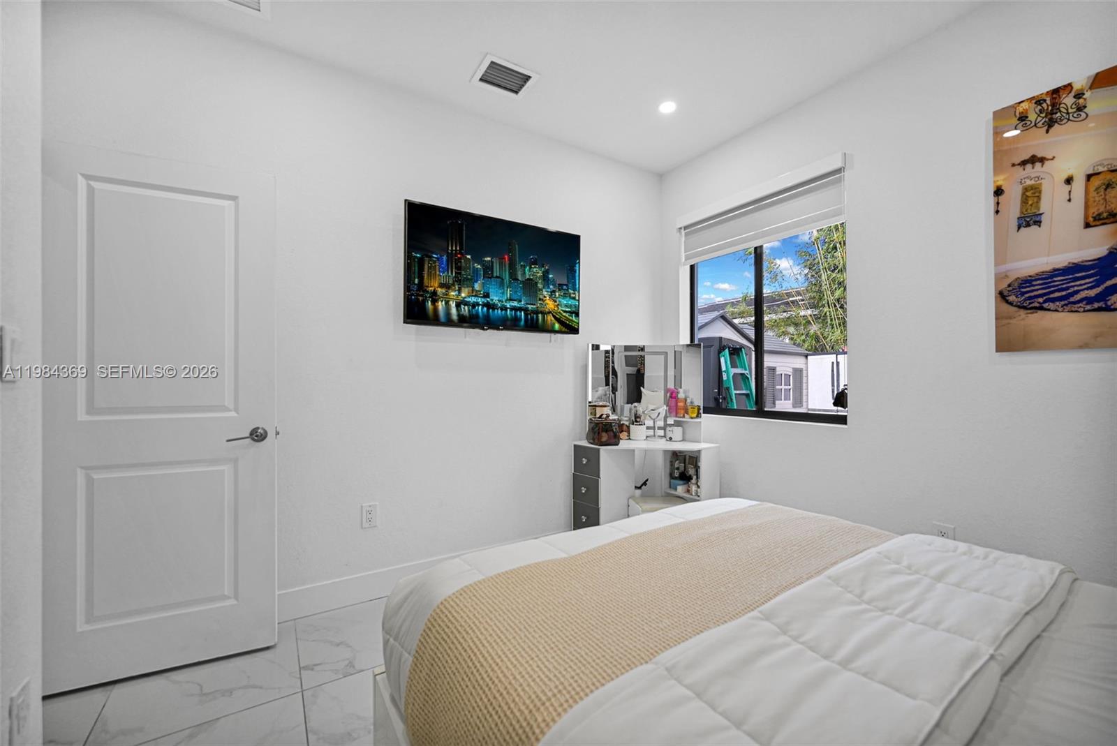 13334 Southwest 227th Street Miami, FL 33170 - Photo 67 of 69 a bedroom with a bed and a flat screen tv