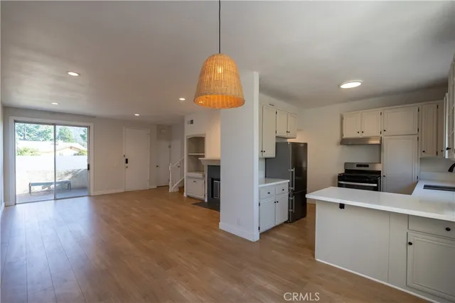 a kitchen with stainless steel appliances a refrigerator sink and stove