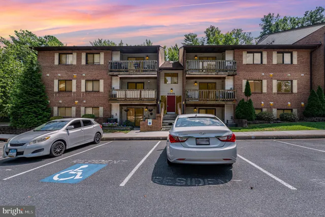 a front view of a house with parking space
