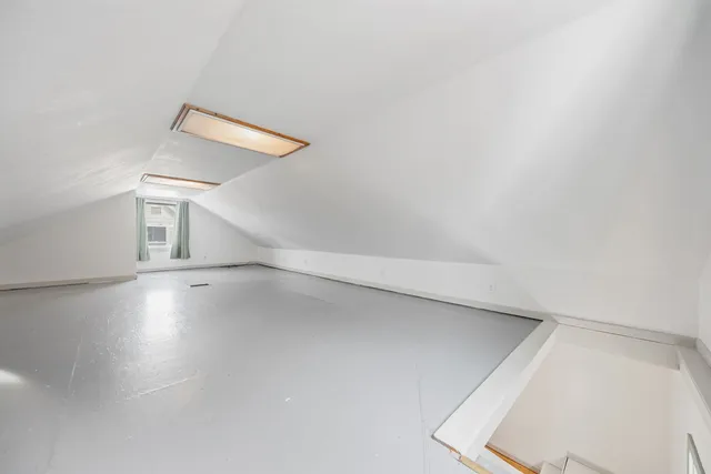 a view of a room with window and wooden floor