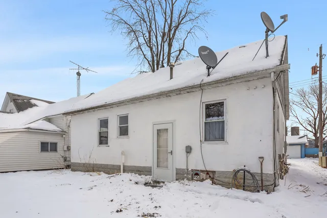 a view of a house with a snow on the road