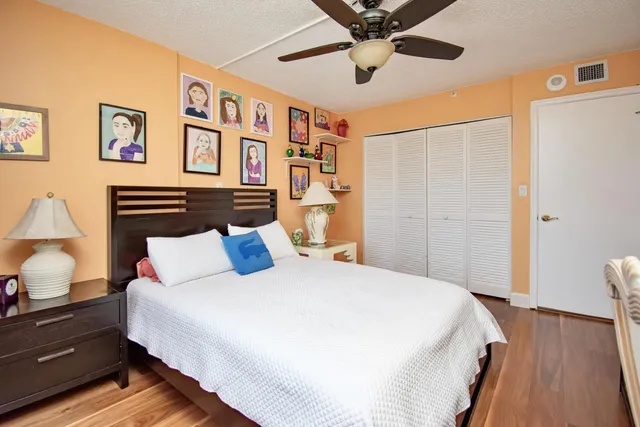 a bedroom with a large bed and a chandelier