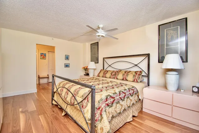 a bedroom with a bed and a night stand