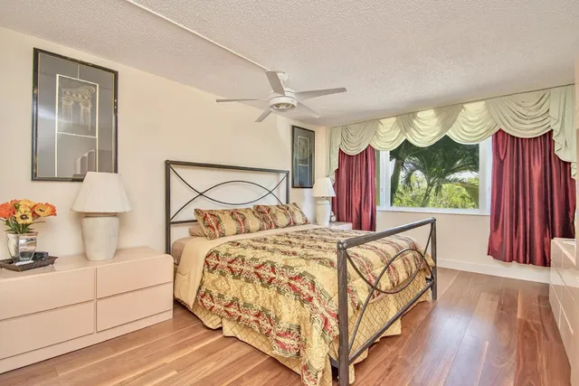 a bedroom with a bed and large window