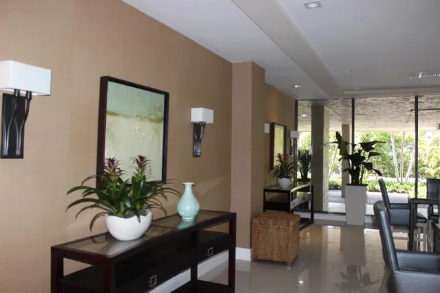 a living room with furniture and a potted plant
