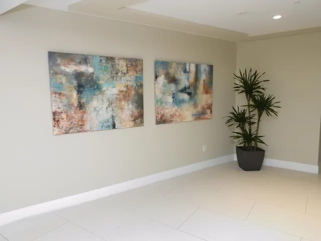 a view of a small space with wooden floor and a potted plant