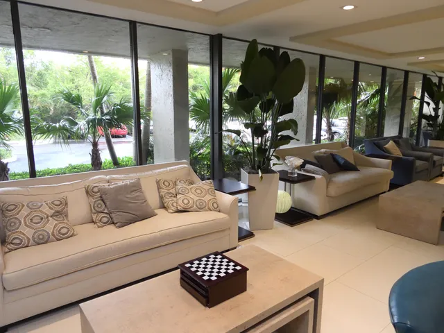 a living room with furniture and a large window with garden view