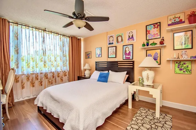 a bedroom with a large bed and a window