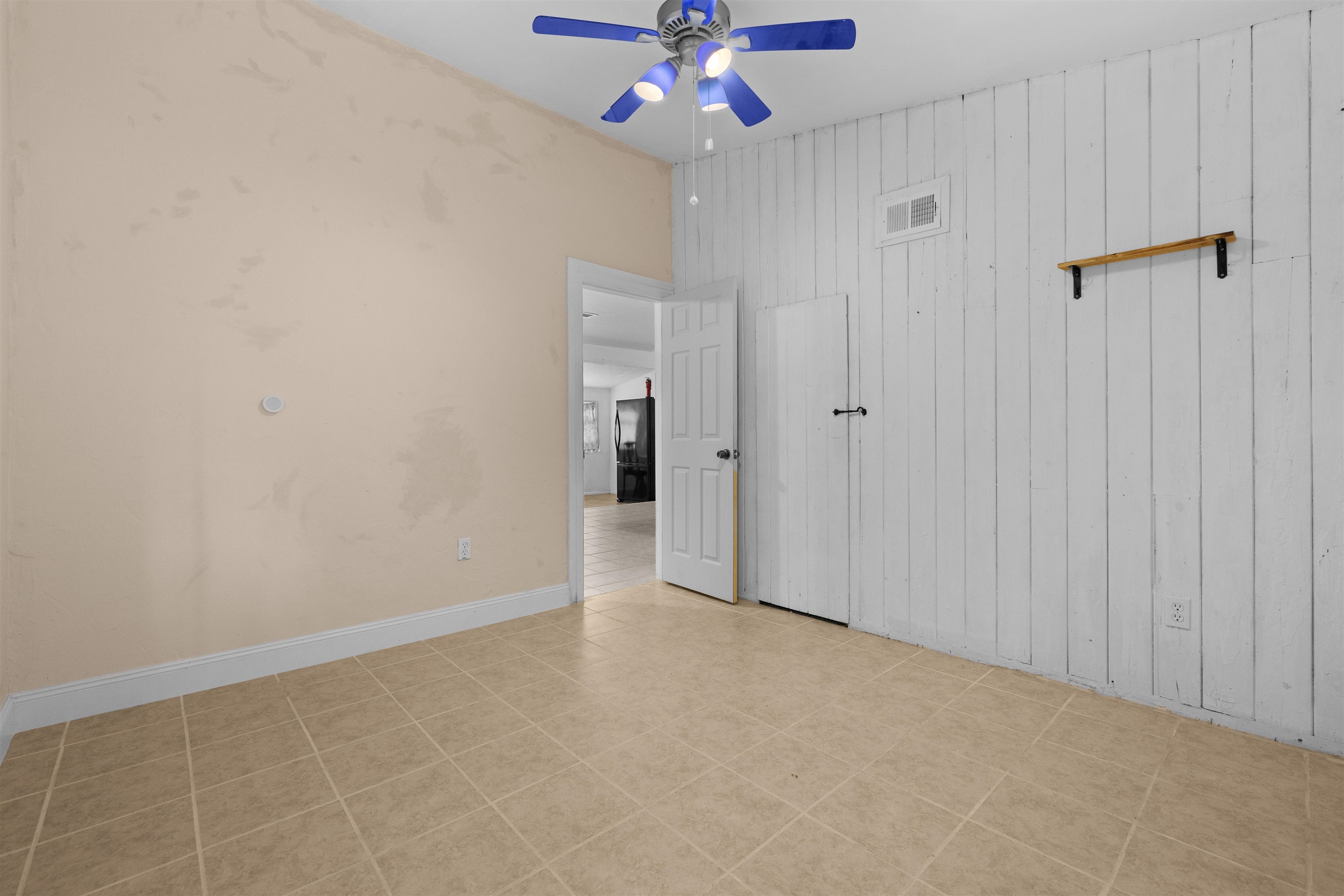 1463 Spring Street St. Augustine, FL 32084 - Photo 16 of 27 wooden floor in an empty room with a chandelier fan