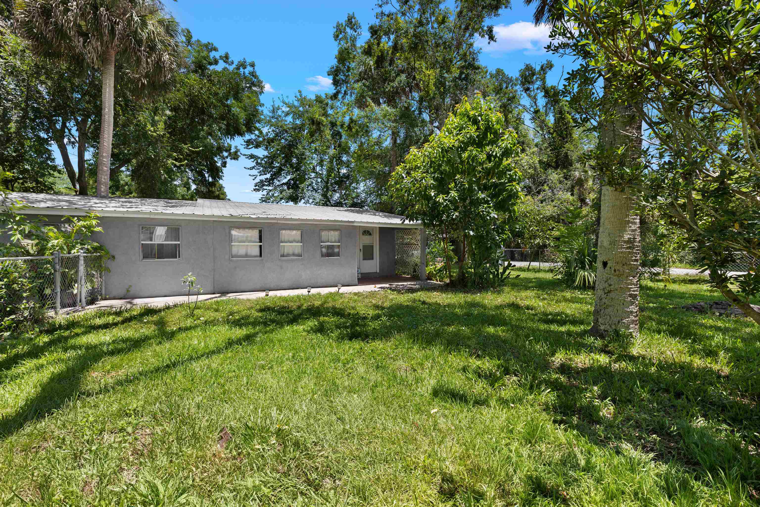 1463 Spring Street St. Augustine, FL 32084 - Photo 22 of 27 a view of a house with a yard and a large tree