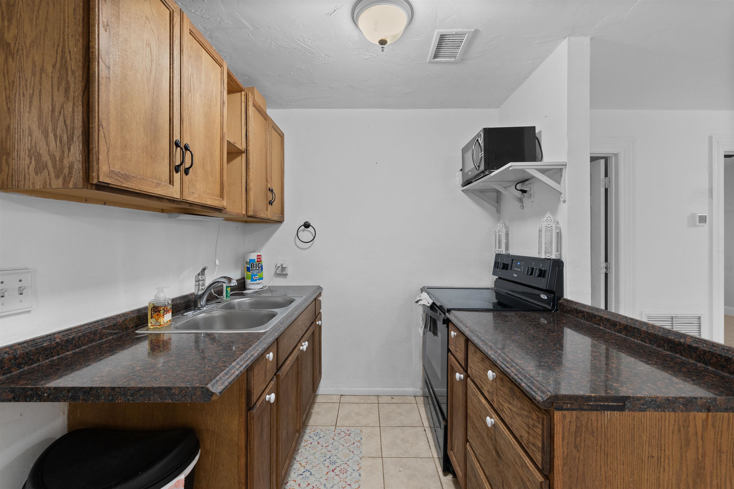 1463 Spring Street St. Augustine, FL 32084 - Photo 8 of 27 a kitchen with stainless steel appliances granite countertop a sink and a stove