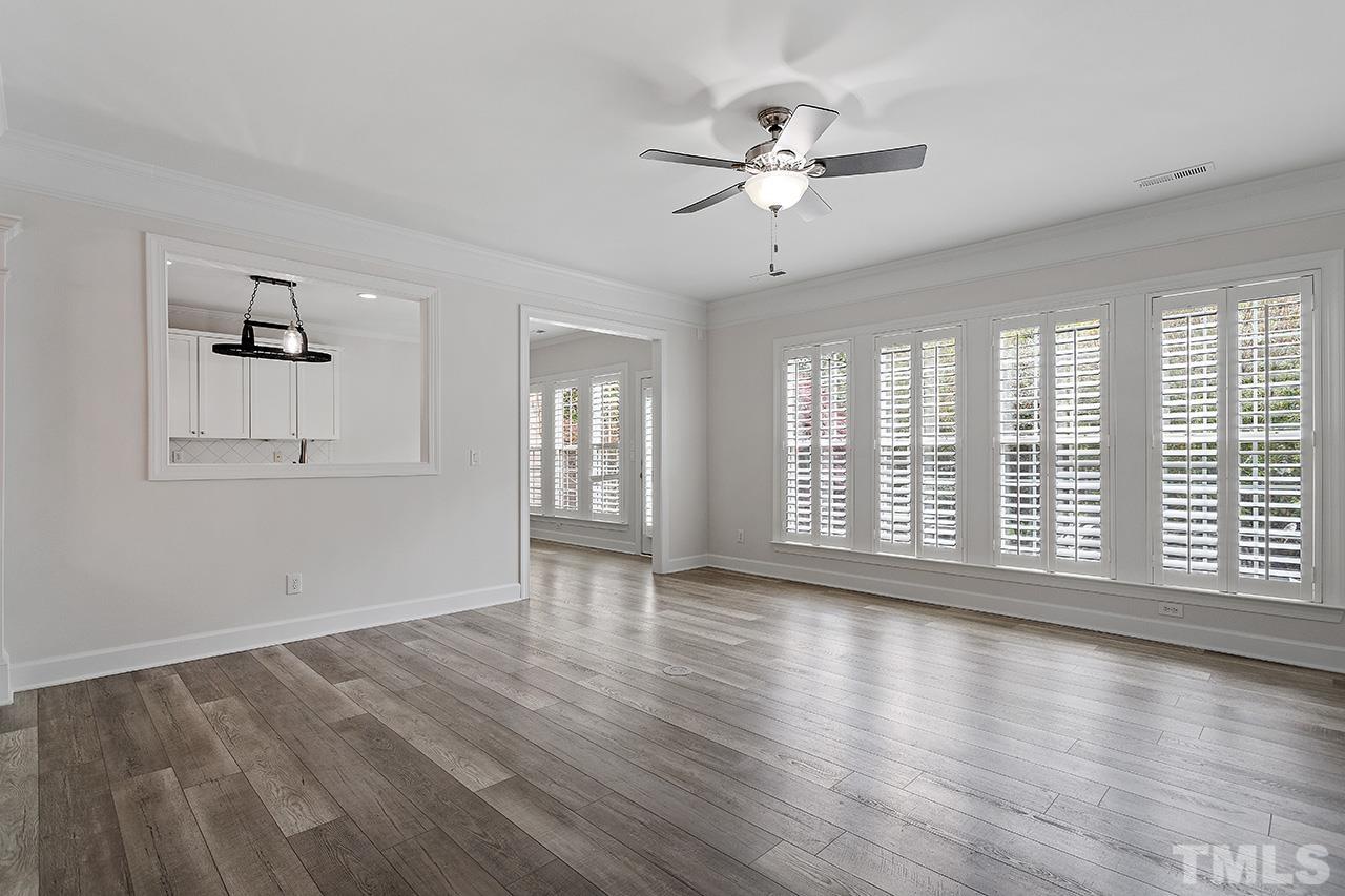 3914 Sunset Maple Court Raleigh, NC 27612 - Photo 3 of 30 a view of an empty room with wooden floor and a window