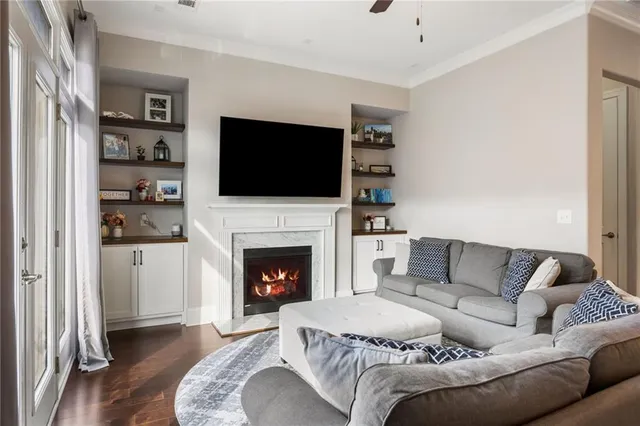 a living room with furniture a flat screen tv and a fireplace